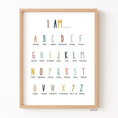 an alphabet poster with the letters in different colors and sizes, hanging on a wall