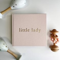 a little lady book sitting on top of a table next to toy rattlers and toys