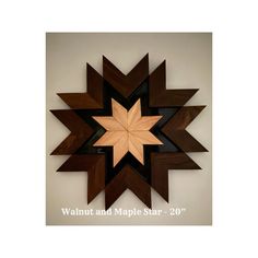 a wooden star hanging on the wall with words walnut and maple stain - 20''