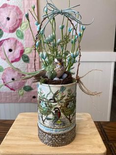 a vase with some plants in it on a table