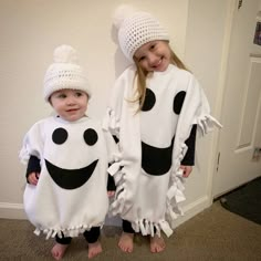 two children dressed up in costumes standing next to each other