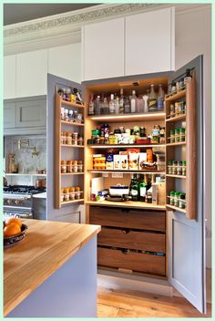 an open cabinet in the middle of a kitchen