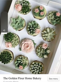 cupcakes decorated with flowers and succulents in a box