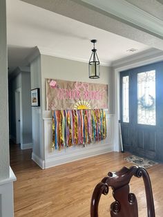 an empty room with wooden flooring and large painting hanging on the wall above it