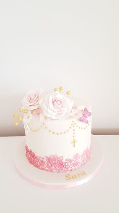 a white cake with pink and gold decorations