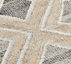 an area rug with different colored squares and lines on it's surface, including the center