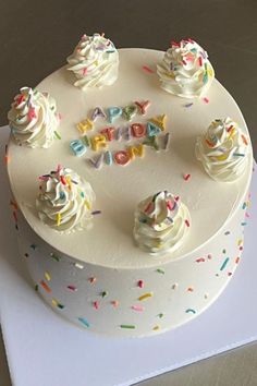 a birthday cake with white frosting and sprinkles