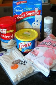 the ingredients for making marshmallows sitting on top of a black countertop