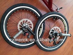 two bicycle wheels with spokes are on the floor