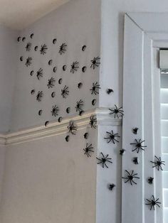 the wall is decorated with black spider decorations