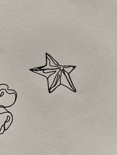 an origami bird and a paper star are drawn on a piece of paper