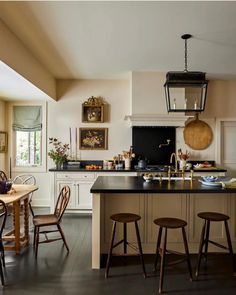 a kitchen with an island and wooden chairs