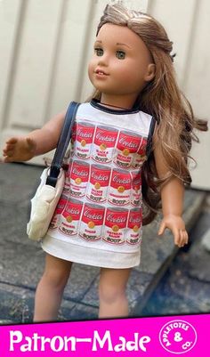 the doll is wearing a dress and carrying a purse