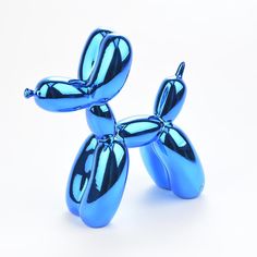 a blue balloon dog sitting on top of a white table