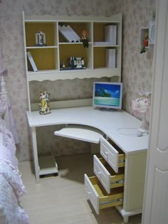 a white desk with drawers and a laptop on it