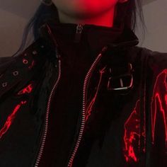 a woman with black hair wearing a red light up jacket