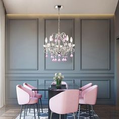 a dining room with pink chairs and a chandelier