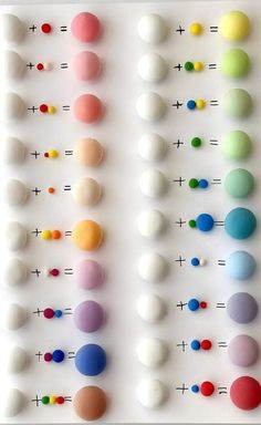 an array of different colored balls arranged on a white surface with numbers in the middle