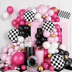 a pink and black birthday party theme with balloons, confetti, lipstick, and cake