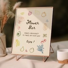 a sign that says flower bar on it next to a vase with flowers in it