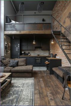 a living room filled with furniture next to a loft style kitchen and dining area on top of a hard wood floor