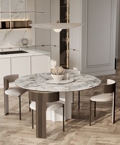 a marble dining table and chairs in a white kitchen with wood flooring on the walls