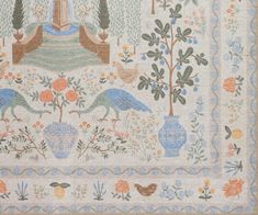 an embroidered wall hanging with birds, flowers and trees on it's border is shown