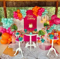 an outdoor birthday party with balloons and decorations