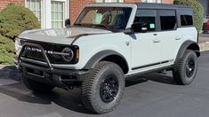 a white truck parked in front of a brick building