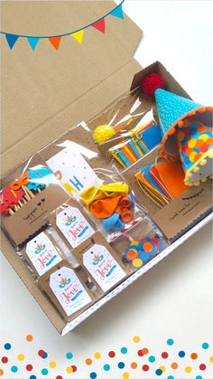 an open box filled with birthday items on top of a table