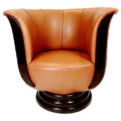 a brown leather chair sitting on top of a wooden base