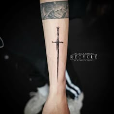 a cross tattoo on the left arm