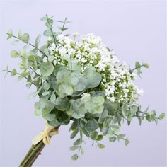 a bouquet of white flowers and green leaves