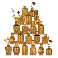 there are many gold vases and flowers on the white background, all in different shapes and sizes