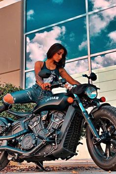 a beautiful woman sitting on top of a motorcycle