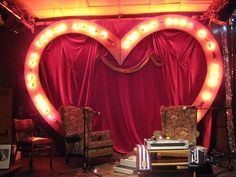 a heart shaped stage set with chairs and lights