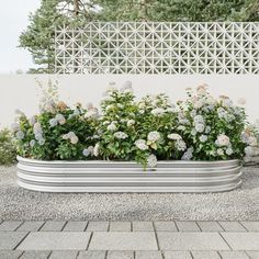 a large metal planter filled with lots of flowers