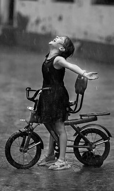 a woman on a bike in the rain