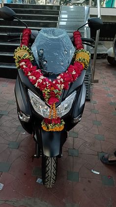 a motorcycle decorated with flowers and garlands