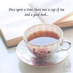 a cup of tea sitting on top of a saucer next to an open book