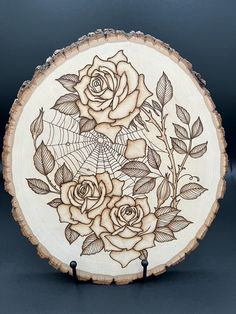 an intricately carved wooden plate with roses on it