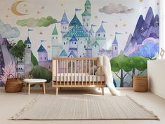 a baby's room with a castle mural on the wall and a crib