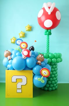 Super Mario Balloons Coming Out of Coin Box with Super Mario Themed Balloon Characters Super Mario Balloon Backdrop, Mario Balloon Backdrop, Bowser Balloon Arch, Super Mario Balloon Decor, Mario Brothers Balloon Decorations, Super Mario Bros Balloons, Mario Bro Balloon Garland, Mario Brothers Balloon Arch