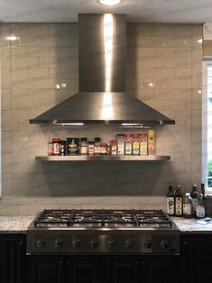 a stove top oven sitting inside of a kitchen next to a counter with bottles on it