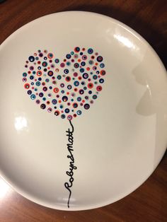 a white plate with an image of a heart shaped balloon and the words congratulations written on it