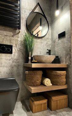 a bathroom with a sink, mirror and shelves in it's corner area next to a toilet