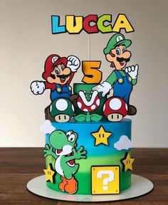 there is a cake with mario and luigi on it, which says lucca 5