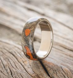 a wedding ring with an orange heart on it