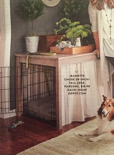 a woman standing next to a dog in front of a table with plants on it