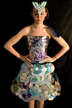 a woman in a dress made out of cds